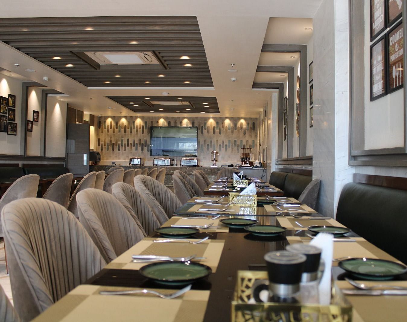 A well-arranged dining space featuring tables with chairs and neatly set cutlery at  BluSalzz Residence, Amritsar